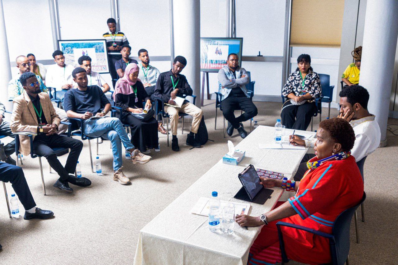 Participants seated in a horseshoe at the embassy dialogue session