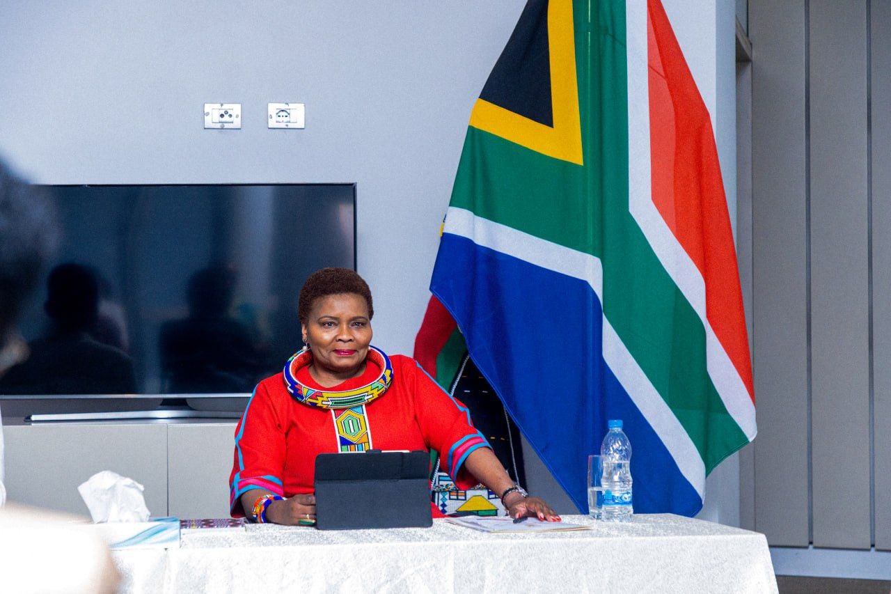 Session facilitator at the panel table with the South African flag