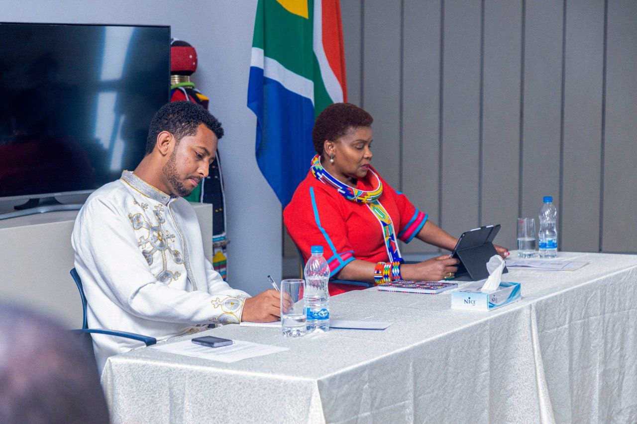 Two speakers in discussion at the panel table