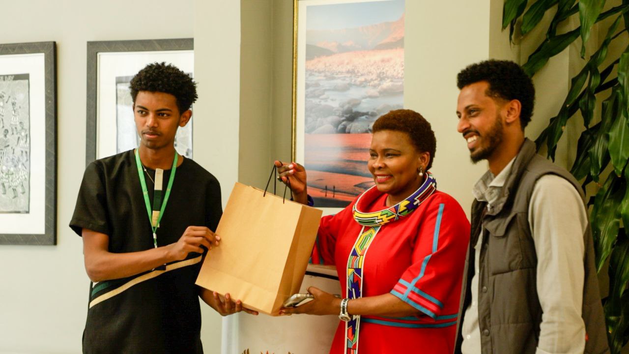 A participant receiving a gift at the close of the event