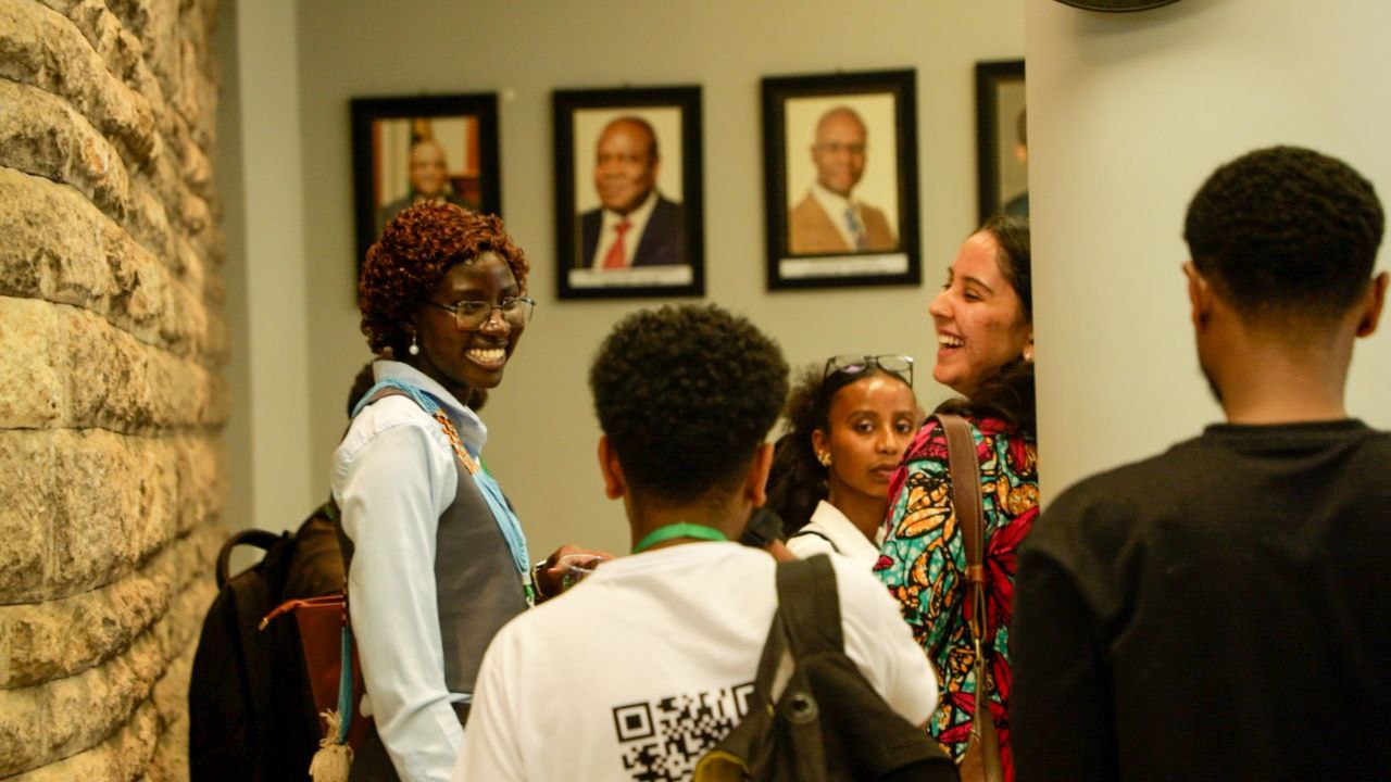 Young participants connecting and laughing in the hallway